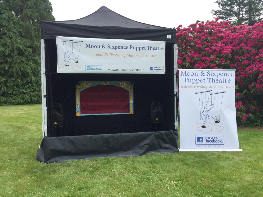 Moon & Sixpence Puppet Theatre outdoor marionette stage at an arts festival.