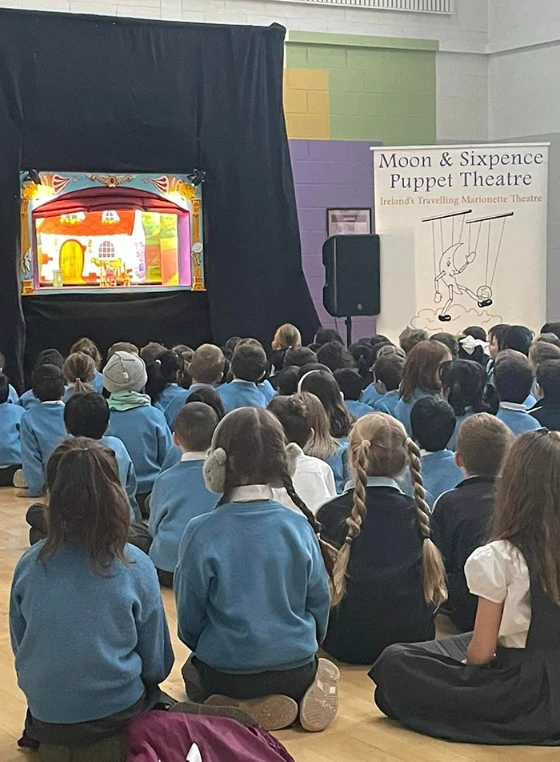 Primary school pupils watching a Moon & Sixpence marionette performance.